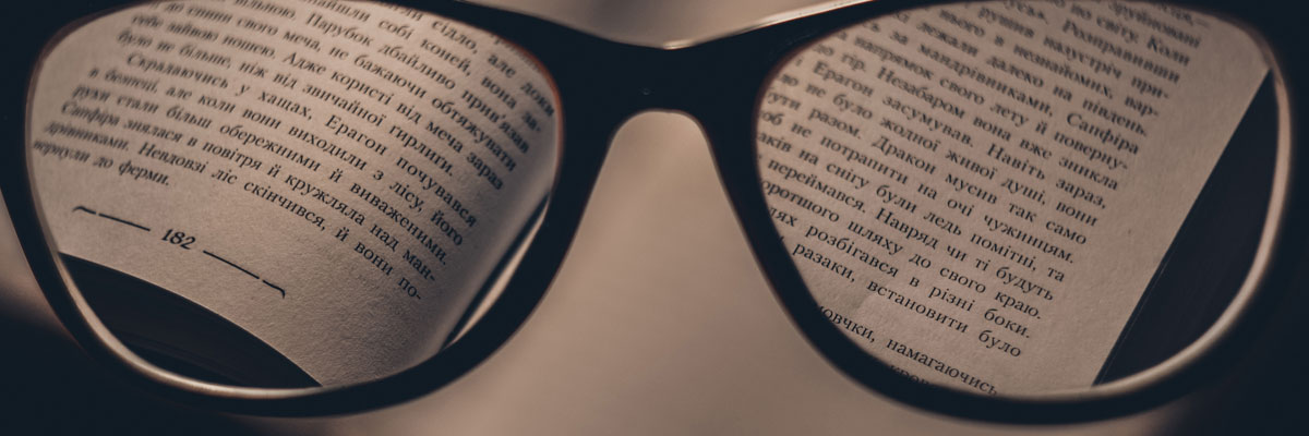 glasses viewing page of book